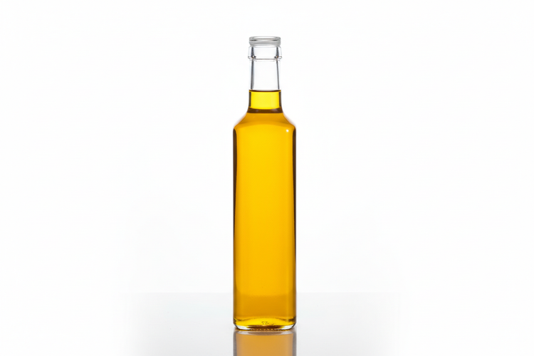 Clear glass bottle of yellow cooking oil on white background, Naturia kitchen essentials